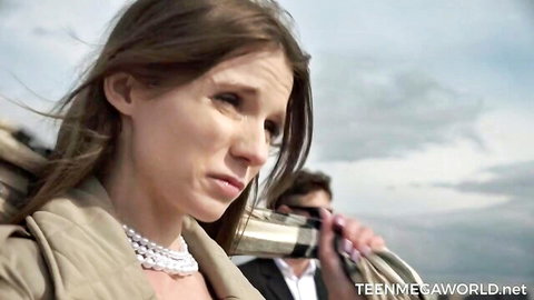 Nelya in intense outdoor teaser with male partner, beige coat and pearls
