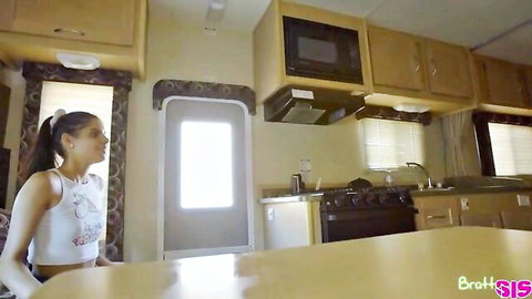 Hot Latina girl in tank top and shorts in RV kitchen on family road trip