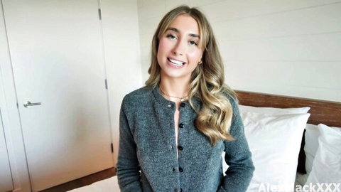 Lily Phillips smiling in gray cardigan, teasing creampie preview
