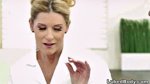 Blonde MILF doctor in open white coat teases with seductive mouth gesture in medical office