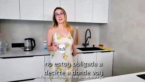 Blonde MILF in sheer floral dress holding mug in kitchen tease
