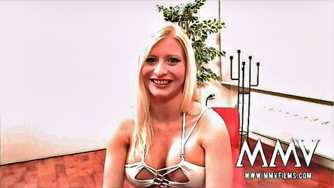 Smiling blonde with huge tits in revealing white strappy lingerie