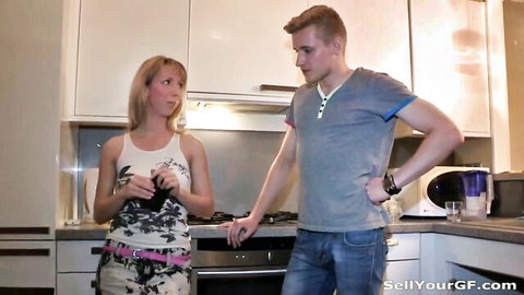 Young blonde babe in skimpy tank top and short skirt chats with handsome guy in kitchen