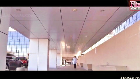 Sexy South Asian doctor in white coat walking in modern hospital parking garage naughty medical scene
