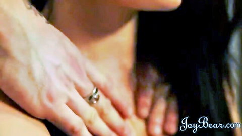 Man's strong hand grips woman's neck intensely from behind in sensual foreplay