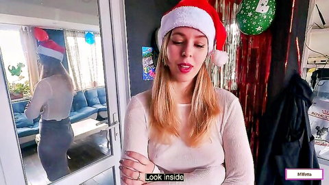 Naughty blonde MILF in Santa hat teases cleavage in low-cut sweater Xmas webcam