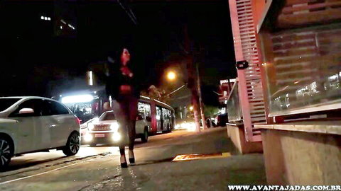 Brazilian long-haired bride walking in heels on nighttime street, teasing domination vibe