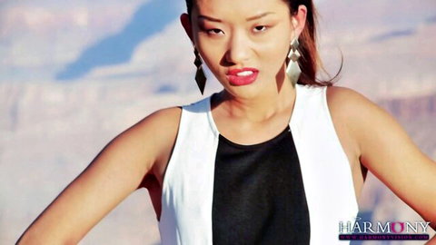 Alina Li seductive pose in black white dress, arms extended, pouty lips