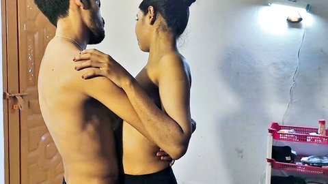 Sexy Indian couple embraces topless in bedroom, her bare tits pressed against his muscular back