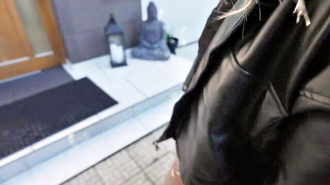 Babe flashing shaved pussy through unzipped black leather pants on outdoor porch