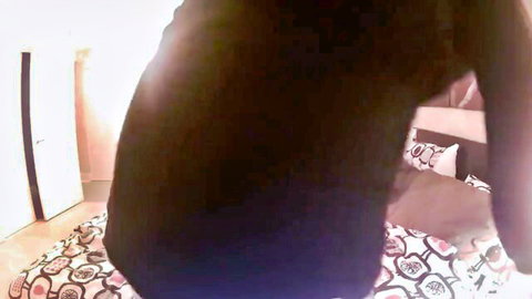Ebony babe in tight black dress bent over colorful bed teasing her thick ass
