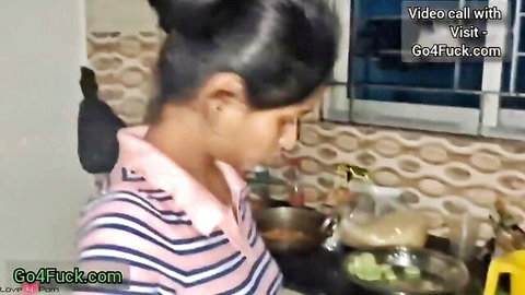 Sexy Indian babe in pink striped top cooking in kitchen on video call