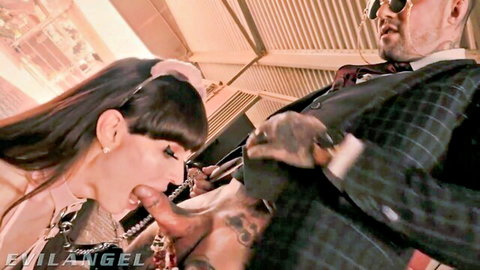 Natalie Mars deepthroats suited tattooed man in kinky oral scene
