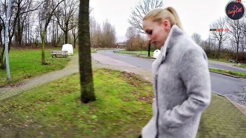 Lucy Cat blonde walking outdoors in gray coat tease
