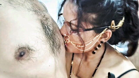 Sensual Indian bhabhi in pigtails and gold jewelry kissing man's chest intimately