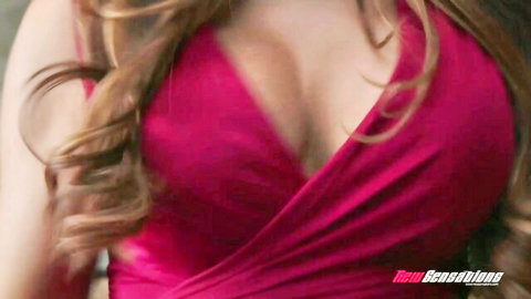 Mercedes Carrera in low-cut purple wrap dress with deep cleavage