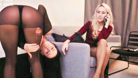 Blonde lady boss dominates slim Asian submissive in stockings with strapon