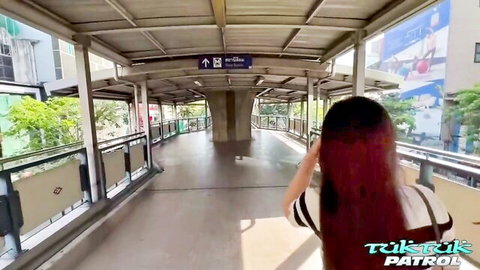 Cherry B walking on urban bridge in TukTuk Patrol adult video