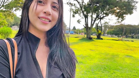 Chicadulce69 smiling seductively in park, teasing in black zip-up top