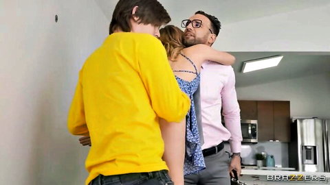 Coco Lovelock in intimate threesome hug with men in kitchen
