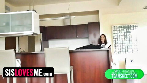 Lily Jordan teases in white top and black pants on kitchen counter