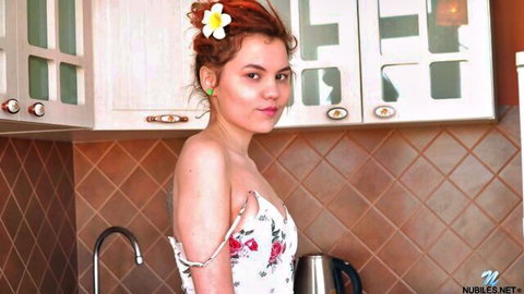 Petite redhead babe with small tits and puffy nipples teasing in floral dress in kitchen