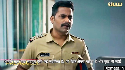 Handsome South Asian Indian police officer in uniform with mustache staring intensely