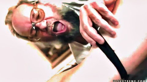Bearded old man in glasses gripping thick black dildo with wide open screaming mouth