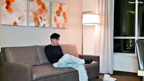 Young Asian man lounging on couch watching laptop in stepmom POV fantasy