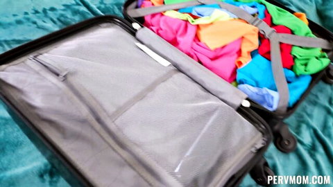 Skylar Snow packing colorful lingerie in open suitcase