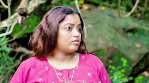 Busty Indian wife in pink saree, thoughtful pose outdoors
