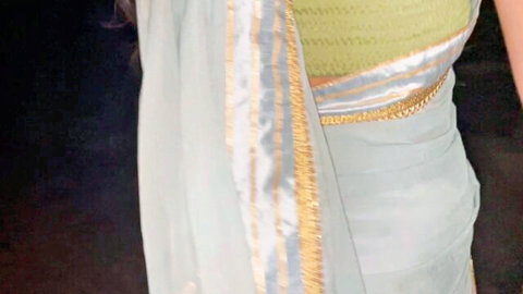 Sexy Indian Bhabhi in green blouse and grey saree, midriff exposed