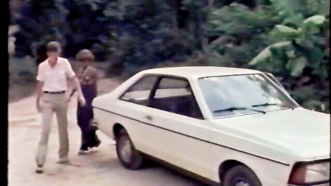 Karibische Frühlese in outdoor tease with white guy by car in jungle setting