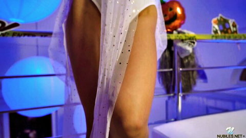Tiffany Tatum in sparkling white dress, teasing legs in Halloween Nubiles scene
