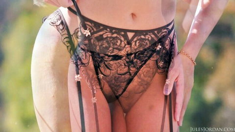 Curvy babe in sheer black lace garter lingerie pulling straps revealing pussy mound