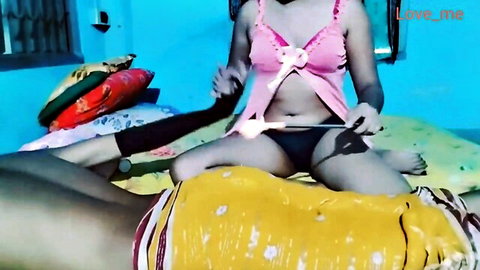 Indian wife in frilly pink lingerie holds thick pink dildo teasing husband on bed