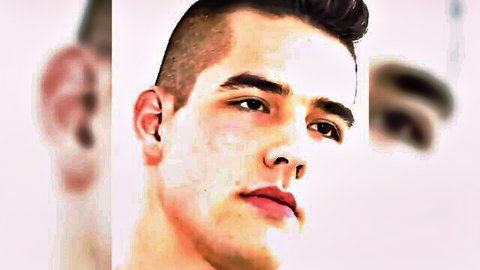 Handsome military stud with buzzed haircut stares seductively in closeup gay tease