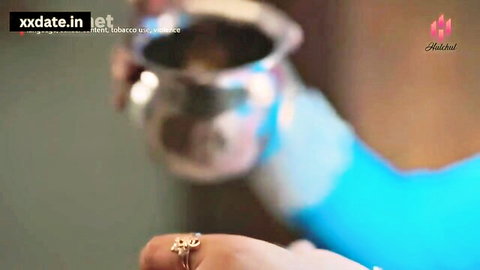 Indian housewife Nasha Dekar in blue outfit holding cup, juicy butt tease
