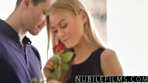 Nancy A in black dress holding rose with lover, romantic foreplay moment