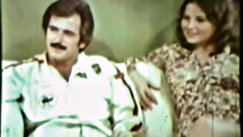 Vintage Danish couple smiling on couch in retro threesome porn preview