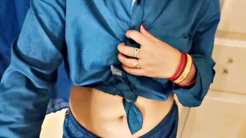 Sexy Desi Indian Bhabhi in tied teal shirt exposing flat navel