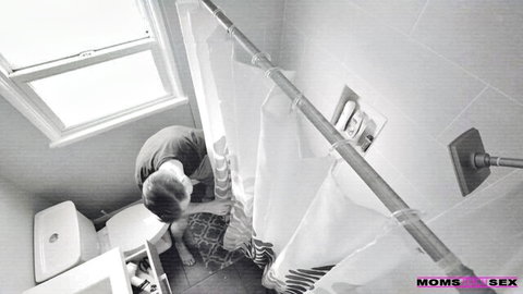Young man peeking behind shower curtain in bathroom voyeur tease