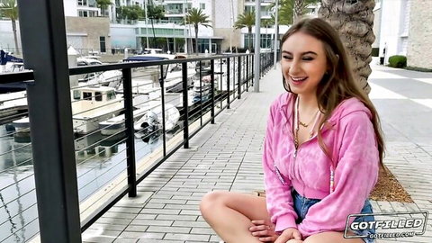 Penelope Kay smiling in pink hoodie by marina, teasing natural tits preview
