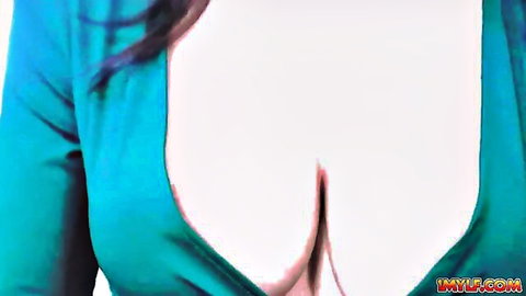Hot MILF with massive tits in low-cut teal dress, teasing cleavage