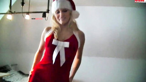 Blonde babe in skimpy red Santa dress with big bow and hat posing seductively smiling