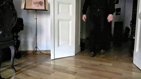 Moiraohara gothic cosplayer in black dress stands seductively in doorway