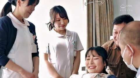 Asian nurses in uniforms smiling with patient in hospital bed JAV thumbnail