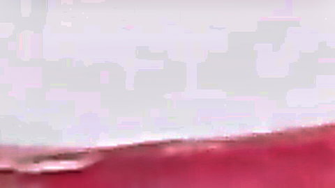 Blurry closeup of wet pink pussy lips glistening in erotic pink light