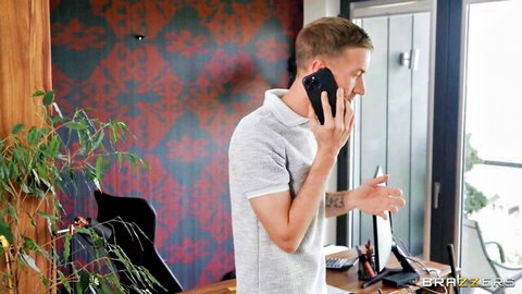 Handsome man in gray polo on phone, teasing office call in Brazzers scene