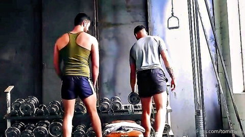 Two muscular gay hunks in tight gym shorts showing off firm asses from behind